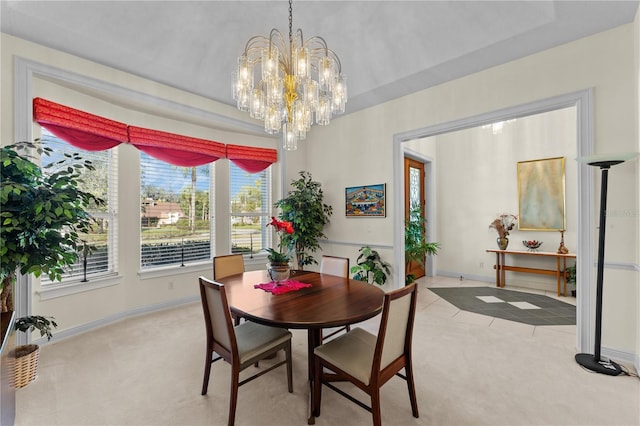 carpeted dining area featuring a chandelier