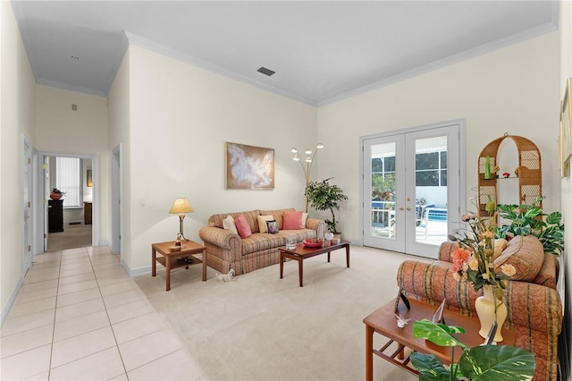 living room with light tile patterned floors, crown molding, and french doors