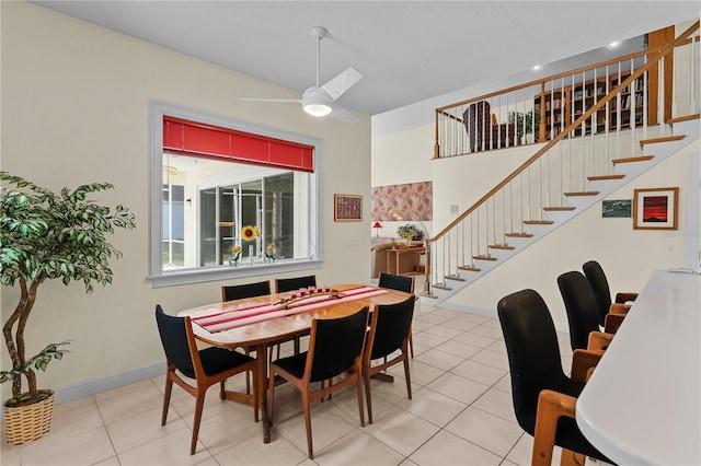 tiled dining space with ceiling fan