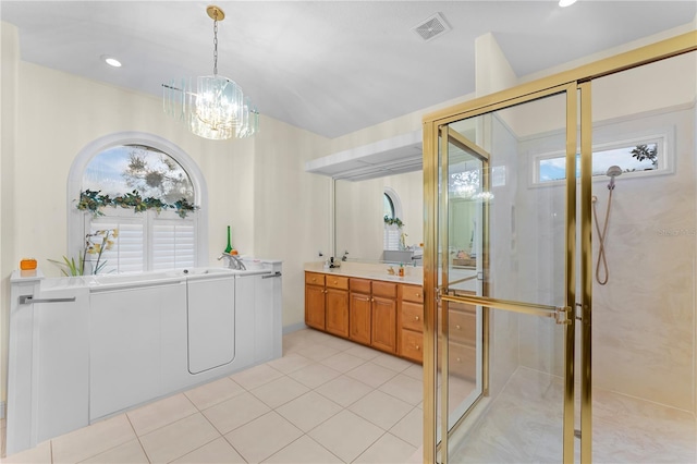 bathroom with tile patterned floors, vanity, a chandelier, and a shower with shower door