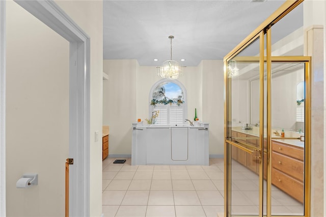 bathroom featuring tile patterned flooring, vanity, and a chandelier