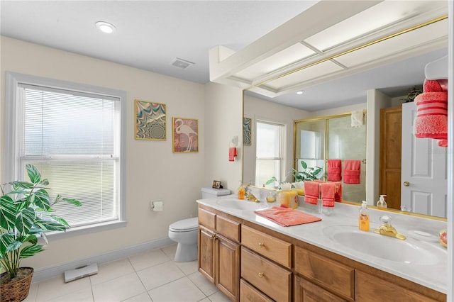 bathroom featuring tile patterned floors, toilet, vanity, and walk in shower