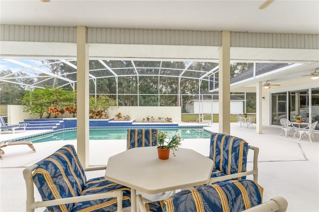 view of swimming pool featuring glass enclosure and a patio area