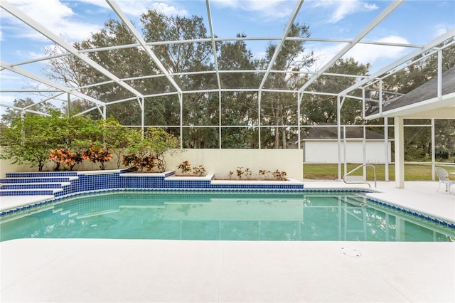 view of swimming pool featuring a lanai and a patio