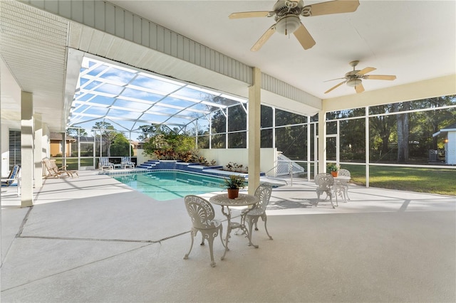 view of pool featuring ceiling fan, a patio, and glass enclosure