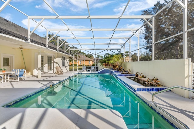 view of pool with ceiling fan, a patio area, and a lanai