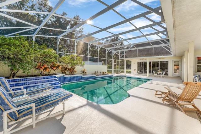 view of swimming pool with a patio area and a lanai