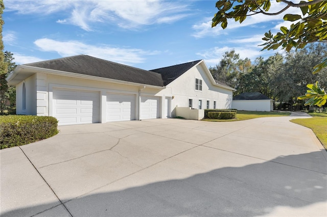 view of side of property with a garage and a yard