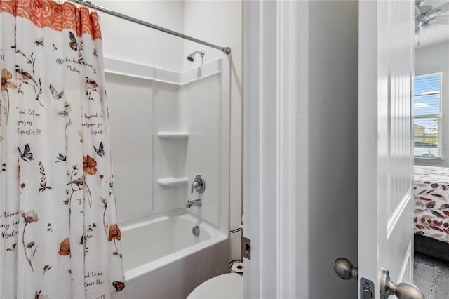 bathroom with shower / bath combo with shower curtain and toilet