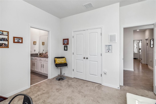 interior space with sink and light carpet