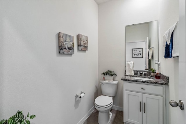 bathroom featuring tile patterned floors, vanity, and toilet