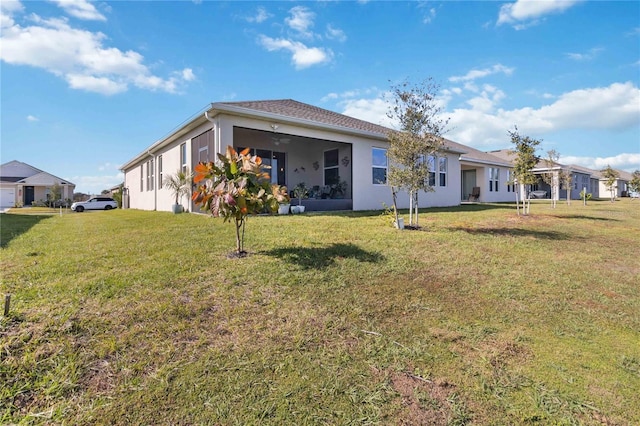 rear view of house with a yard