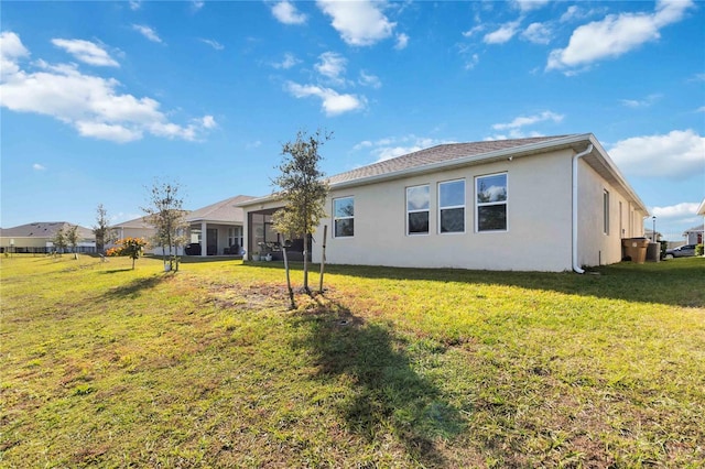 back of property featuring a lawn