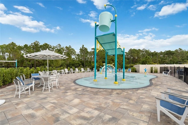 view of playground featuring a patio area