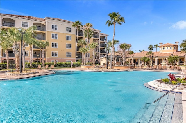 view of swimming pool with pool water feature