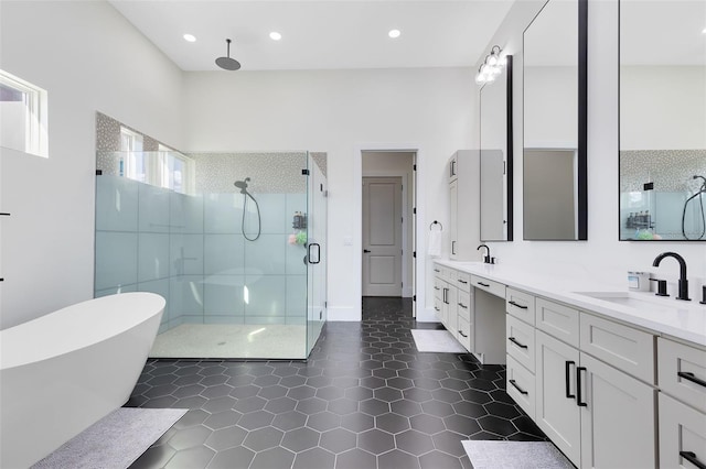 bathroom featuring tile patterned floors, vanity, and shower with separate bathtub