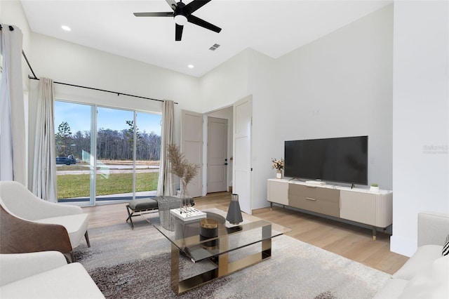 living room featuring ceiling fan and light wood-type flooring