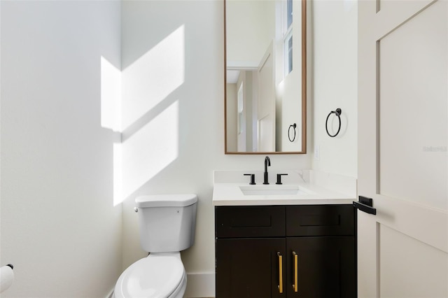 bathroom featuring toilet and vanity