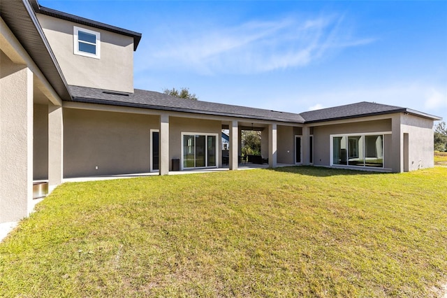 rear view of property with a lawn