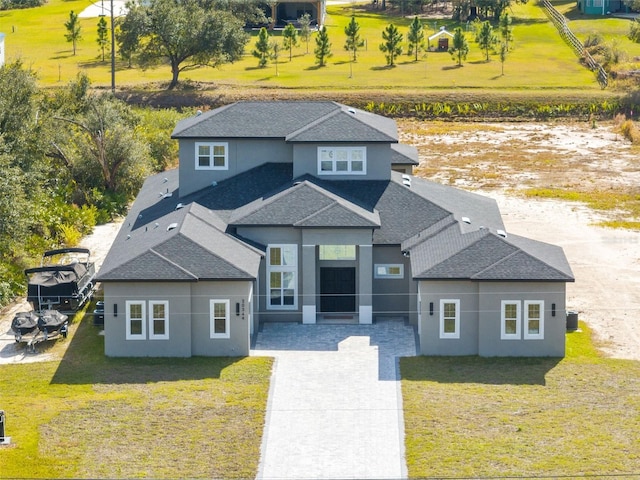 view of front of home with a front yard and central AC unit