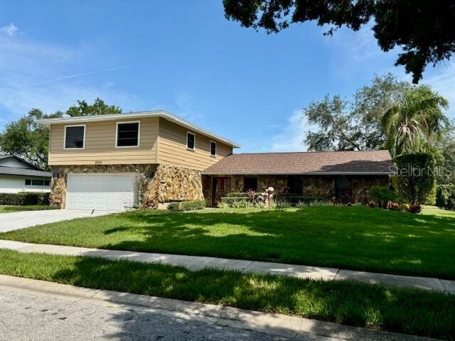 view of front of house with a garage and a front yard