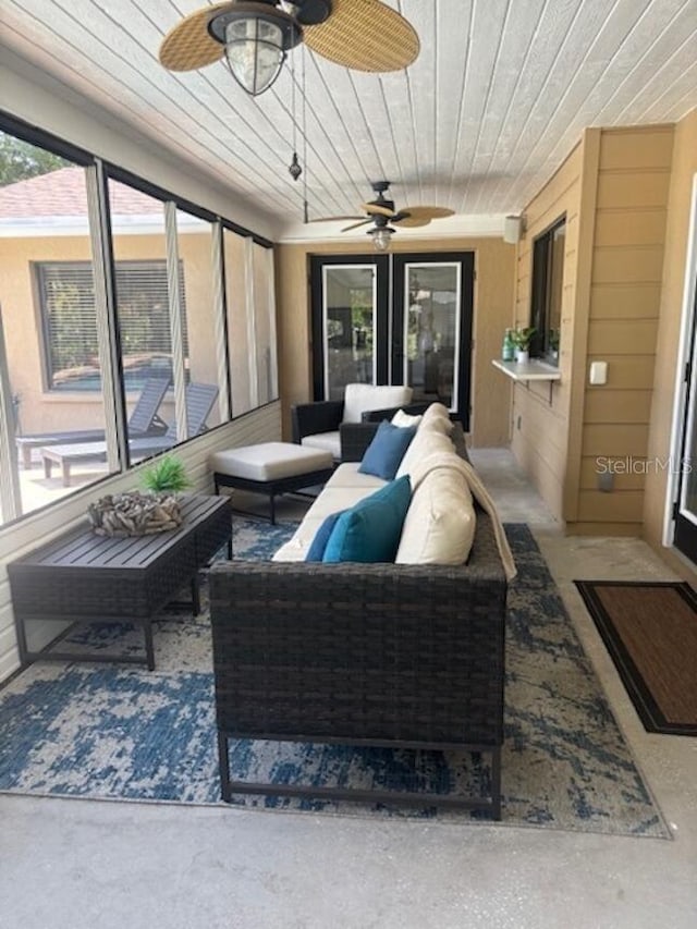 sunroom featuring ceiling fan and wood ceiling