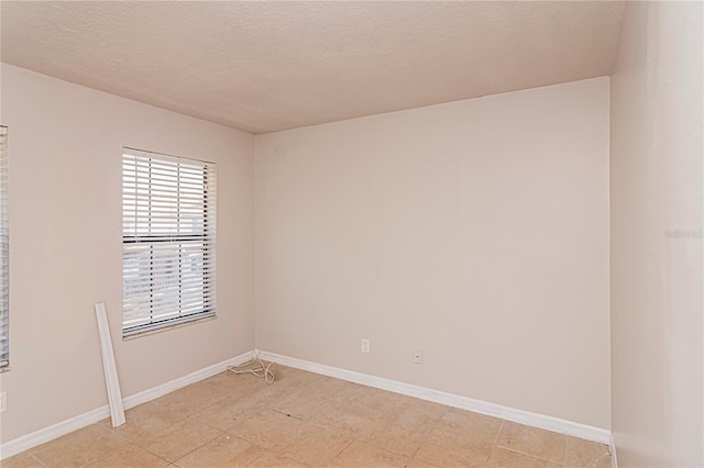 spare room with a textured ceiling