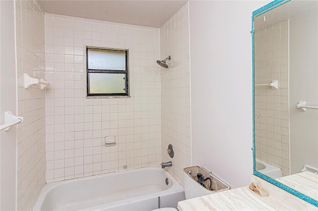 full bathroom with vanity, tiled shower / bath combo, and toilet