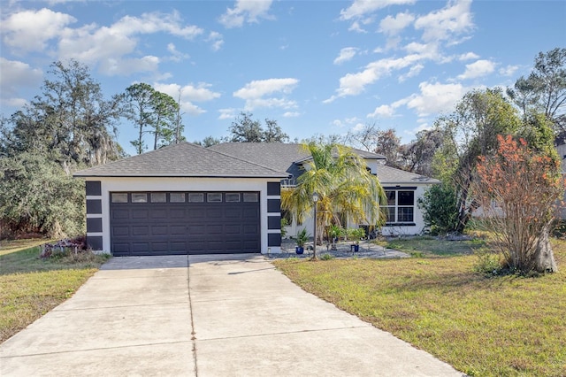 ranch-style house featuring a front yard and a garage