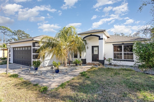 view of front facade with a garage and a front lawn