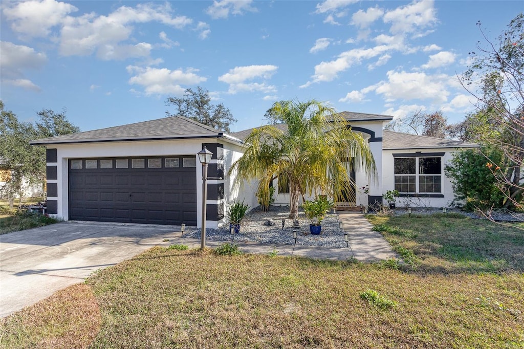 view of front of house featuring a front yard and a garage