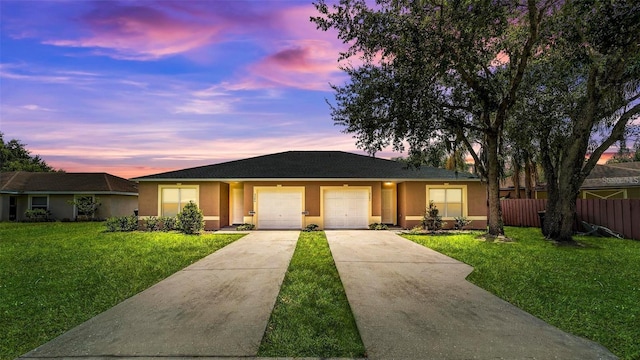 ranch-style house with a yard and a garage