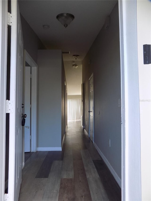 hallway with dark hardwood / wood-style floors