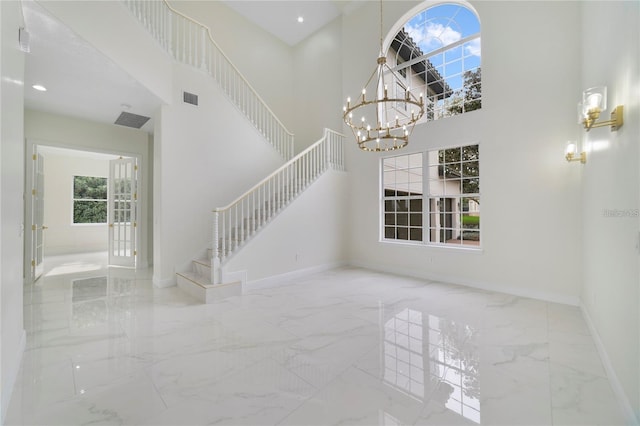 interior space featuring a high ceiling and a chandelier