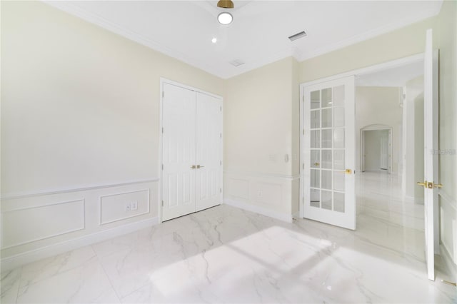 spare room featuring crown molding and french doors