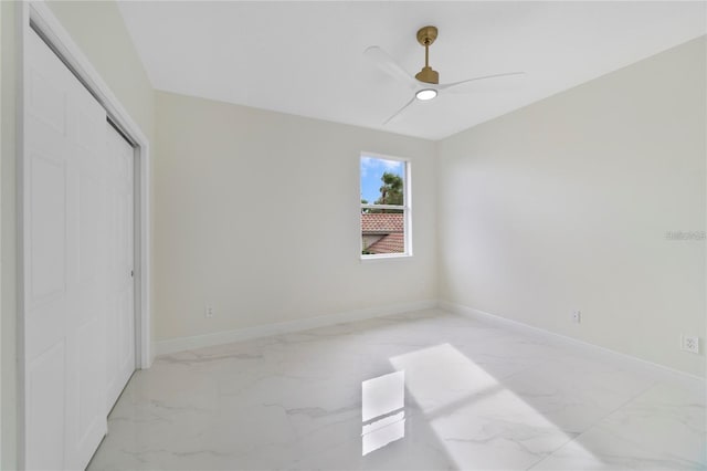 unfurnished bedroom with ceiling fan and a closet