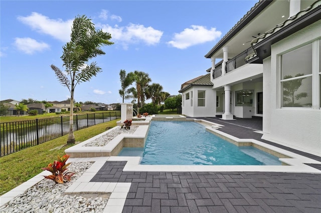 view of pool featuring a water view and a patio