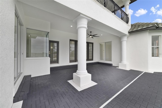 view of patio / terrace with ceiling fan and a balcony