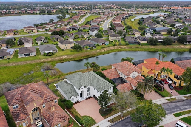 birds eye view of property with a water view