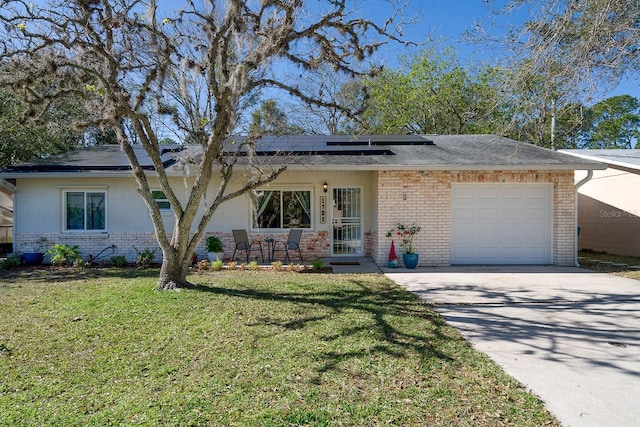 view of front of house featuring solar panels, a front yard, and a garage