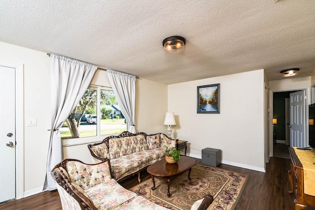 living room featuring a textured ceiling and dark hardwood / wood-style floors