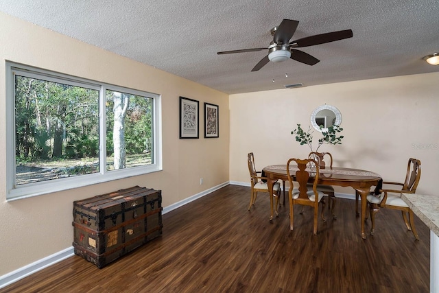 dining space with a textured ceiling, dark hardwood / wood-style floors, and ceiling fan