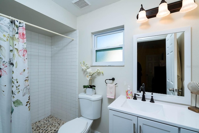 bathroom with a shower with curtain, vanity, and toilet