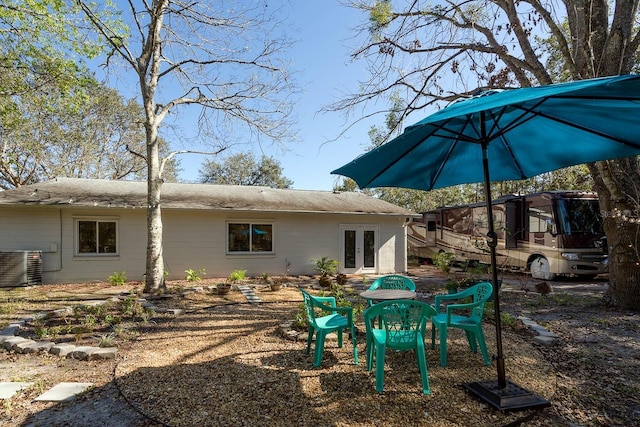 back of property with central air condition unit and french doors