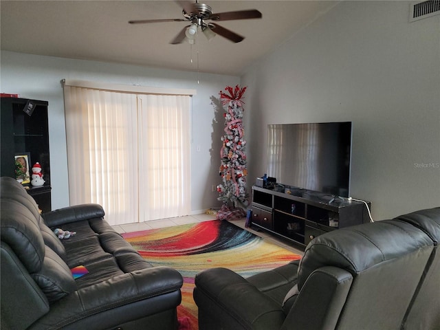 tiled living room featuring ceiling fan and lofted ceiling