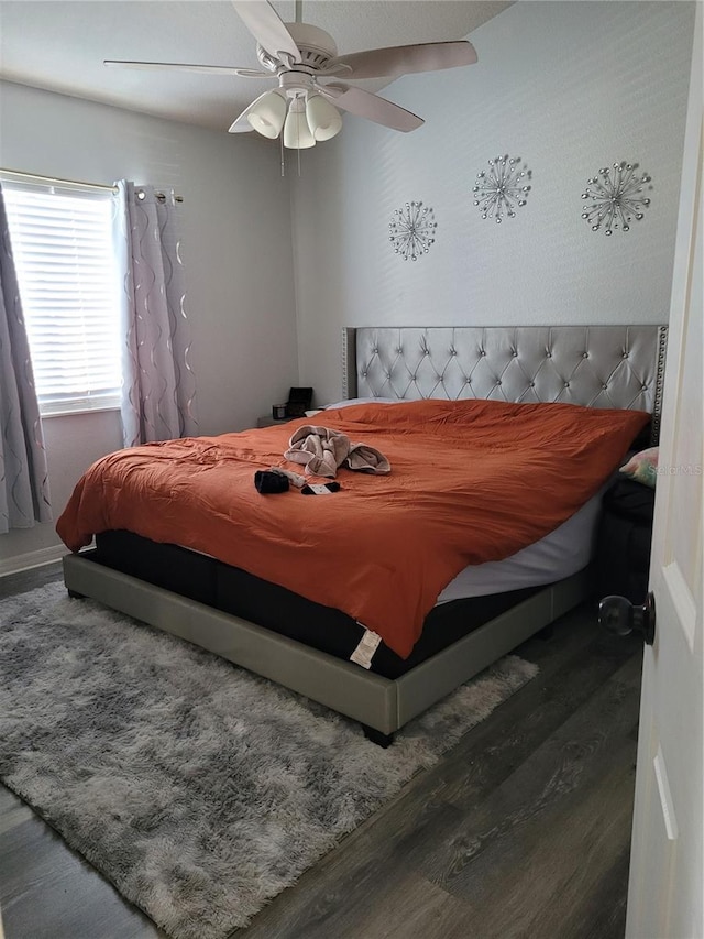 bedroom featuring ceiling fan and dark wood-type flooring