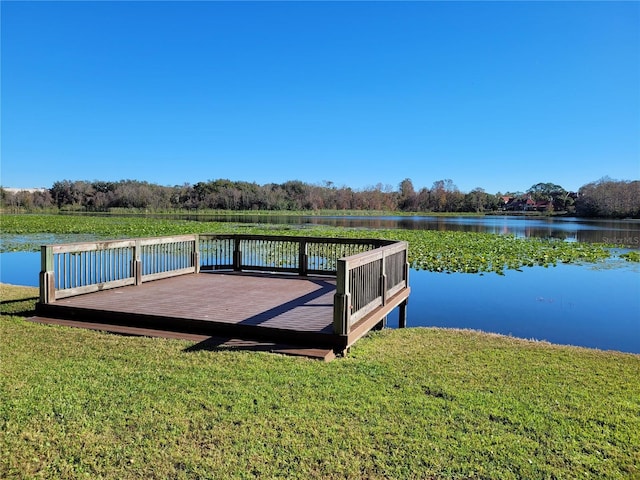 dock area featuring a lawn and a water view