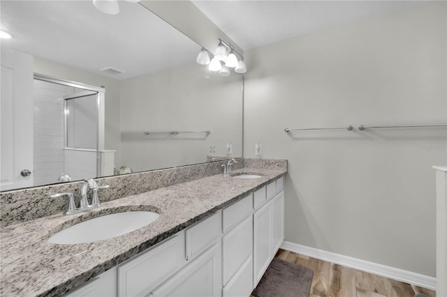 bathroom featuring vanity, hardwood / wood-style flooring, and walk in shower