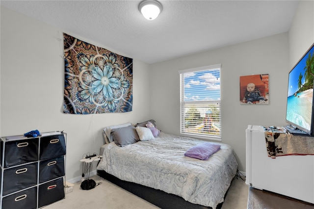 carpeted bedroom featuring a textured ceiling