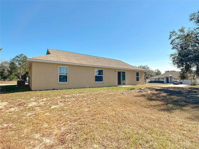 rear view of property with a lawn